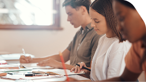 Two female and one male student taking a test.