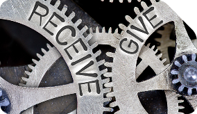 Interlocking gears labeled receive and give.