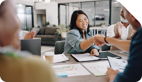 A woman shaking hands at a meeting.