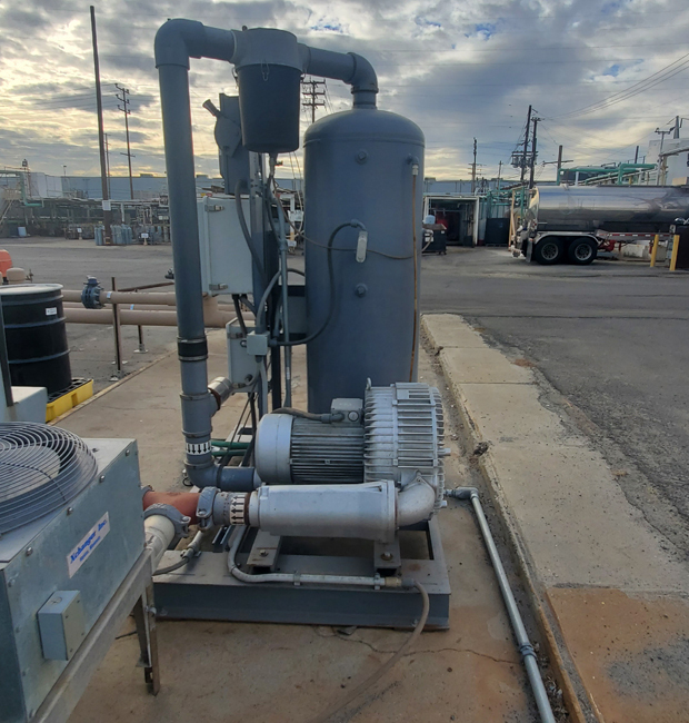 Aboveground treatment system with pumps and piping at an industrial facility.