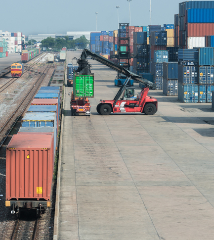 Cargo train platform with freight train container at depot.