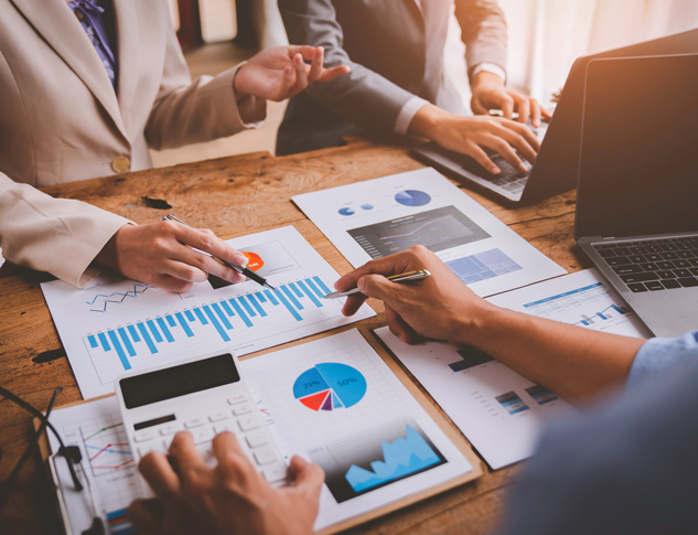 Meeting with office workers hands reviewing charts.