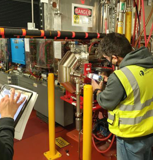 Terraphase staffperson collecting a sample from a stream leading to a reservoir.