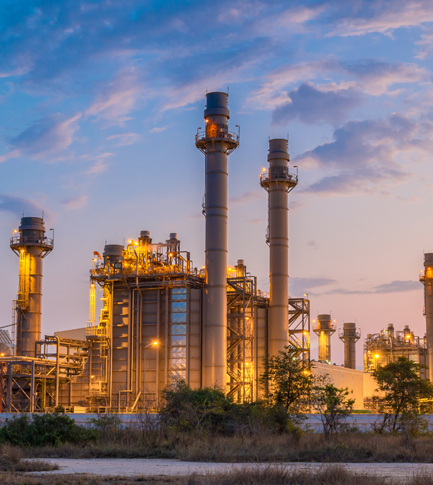 Electrical power plant w lights at twilight.