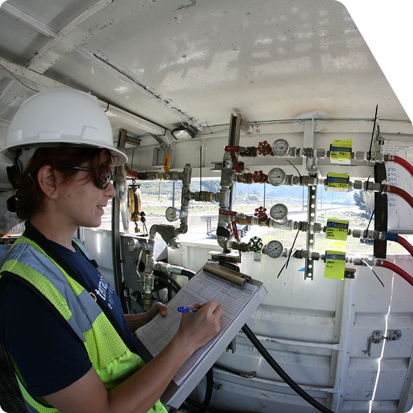 Worker taking notes inside of a trailer.