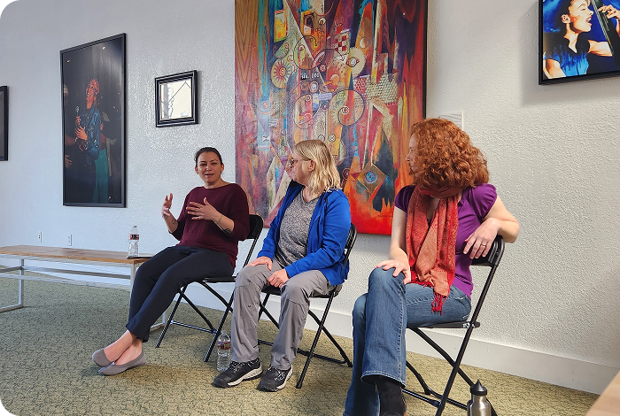 Three women seated having a panel discussion.